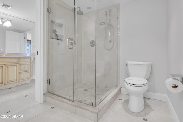 bathroom featuring a shower with door, vanity, toilet, and tile patterned floors