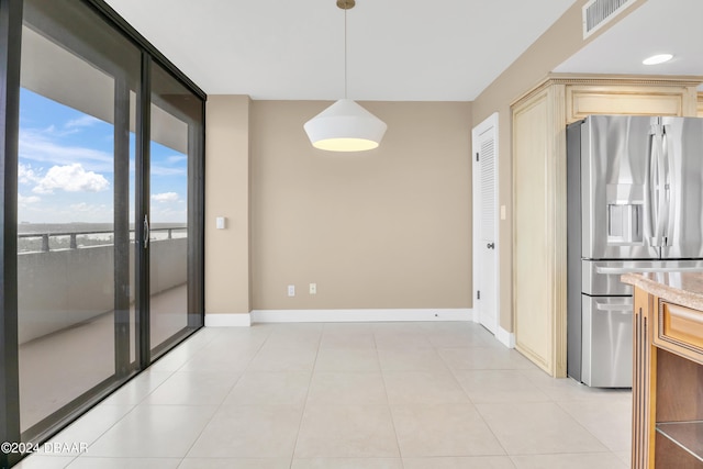 unfurnished dining area with light tile patterned floors