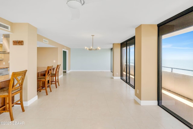 2200 N Atlantic Ave Unit 1602, Daytona Beach, FL 32118 - interior space with floor to ceiling windows, a notable chandelier, baseboards, and visible vents