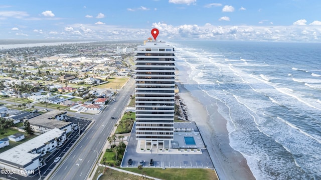 drone / aerial view featuring a beach view and a water view