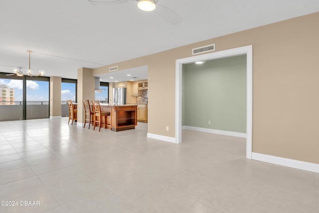 2200 N Atlantic Ave Unit 1602, Daytona Beach, FL 32118 - living room with ceiling fan with notable chandelier, baseboards, and visible vents