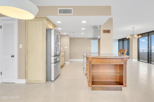 kitchen featuring stainless steel refrigerator with ice dispenser, a chandelier, light tile patterned flooring, light stone countertops, and range hood