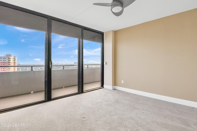 unfurnished room with light colored carpet and ceiling fan