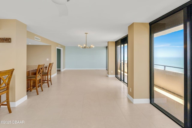 2200 N Atlantic Ave Unit 1602, Daytona Beach, FL 32118 - hallway featuring baseboards, visible vents, floor to ceiling windows, and a chandelier