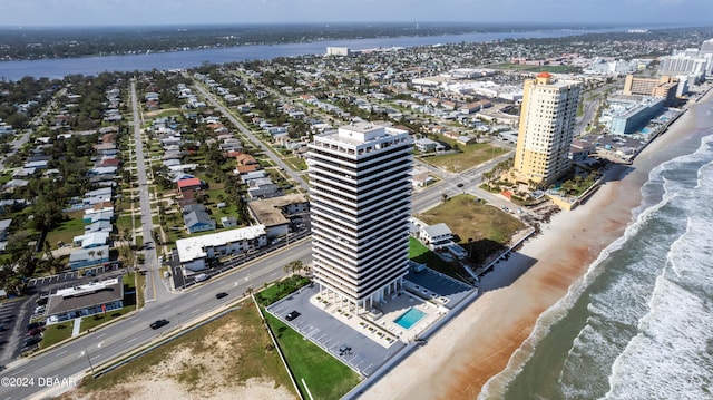 birds eye view of property featuring a beach view and a water view