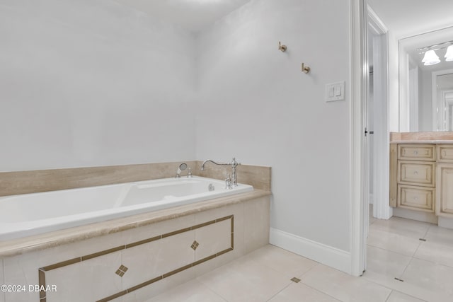 bathroom with vanity, tile patterned floors, and tiled tub