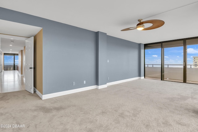 2200 N Atlantic Ave Unit 1602, Daytona Beach, FL 32118 - carpeted empty room with a ceiling fan, tile patterned floors, baseboards, and expansive windows