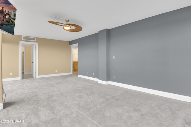 empty room featuring light colored carpet and ceiling fan