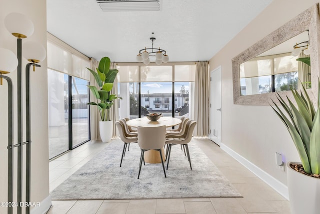 2200 N Atlantic Ave Unit 1602, Daytona Beach, FL 32118 - tiled dining space featuring a wall of windows, visible vents, baseboards, and a healthy amount of sunlight