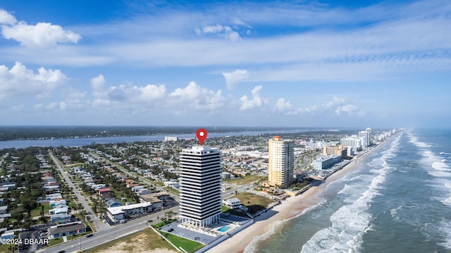 drone / aerial view featuring a beach view and a water view