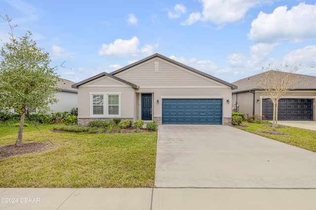 single story home featuring a front lawn and a garage