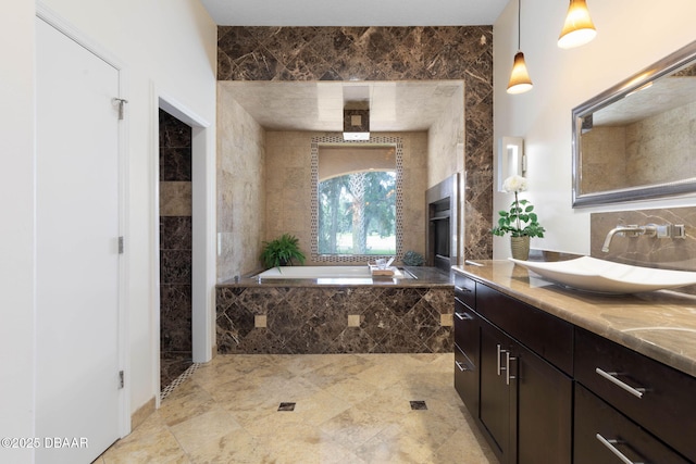 full bathroom with a garden tub and vanity