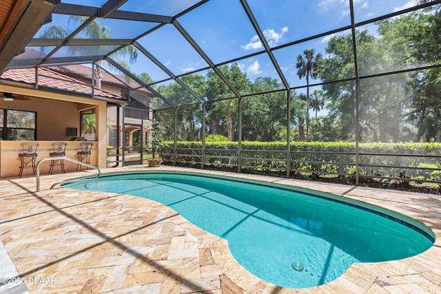 view of swimming pool featuring outdoor dry bar, a patio area, and a fenced in pool