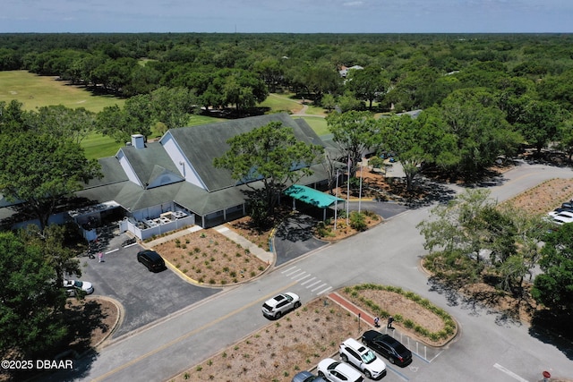 drone / aerial view featuring a forest view