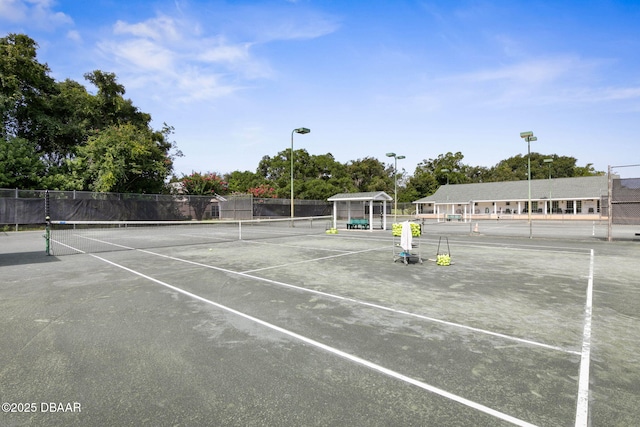 view of tennis court featuring fence