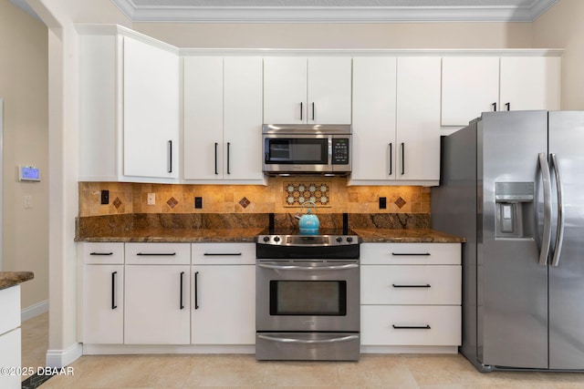 kitchen featuring dark stone counters, appliances with stainless steel finishes, decorative backsplash, and white cabinetry