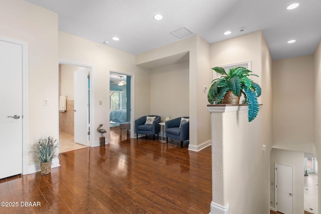 hallway with baseboards, recessed lighting, and wood finished floors