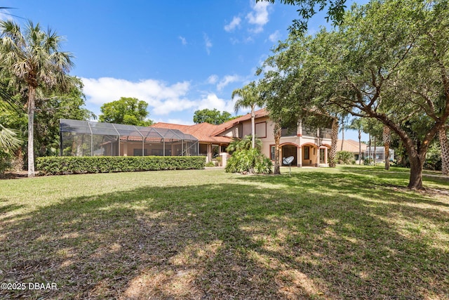 view of yard with glass enclosure