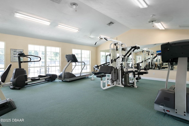exercise room featuring lofted ceiling, a wealth of natural light, carpet flooring, and visible vents
