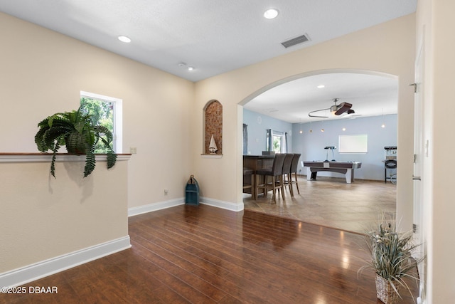 interior space featuring a healthy amount of sunlight, arched walkways, and visible vents