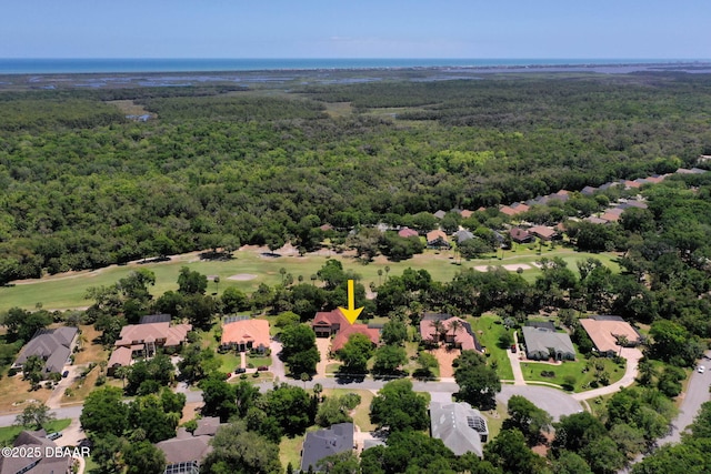 birds eye view of property with view of golf course, a residential view, and a view of trees