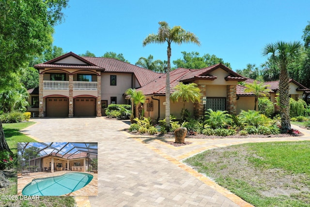 mediterranean / spanish home with stone siding, a balcony, a tile roof, a garage, and stucco siding