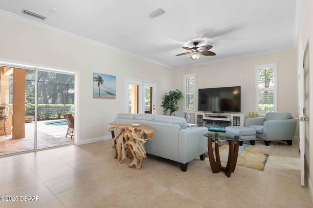 living area with ceiling fan, ornamental molding, baseboards, and visible vents