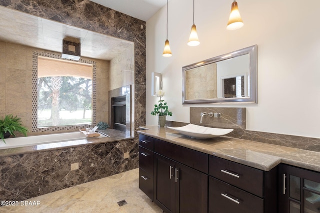 bathroom featuring vanity, decorative backsplash, and a garden tub