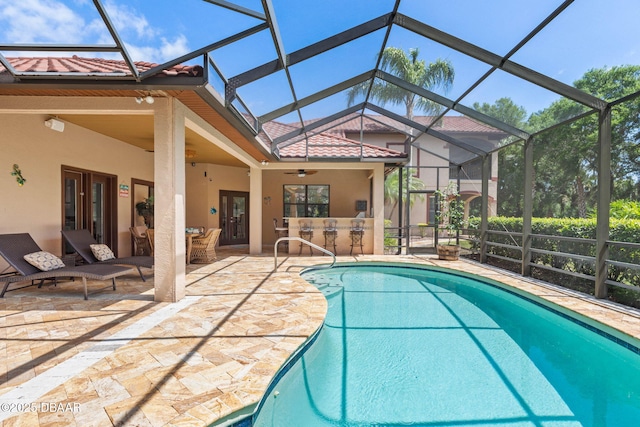 pool with ceiling fan, a patio area, a lanai, and outdoor dry bar