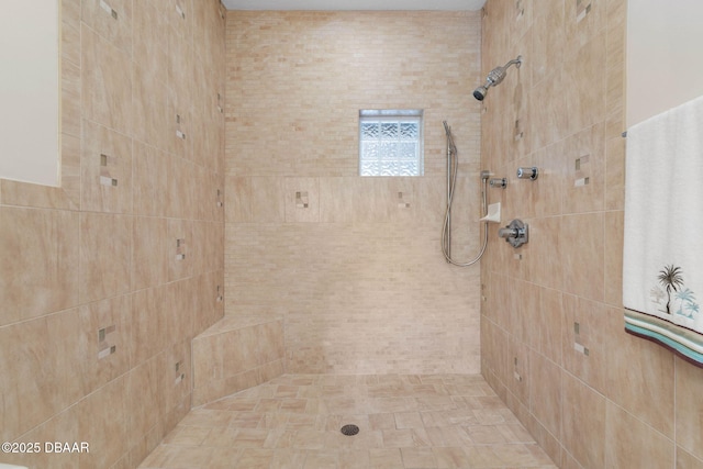 full bath with a tile shower