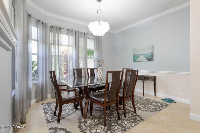 dining room with tile patterned floors, a healthy amount of sunlight, baseboards, and ornamental molding