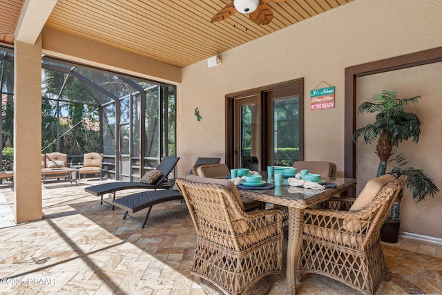 view of patio with an outdoor hangout area, a ceiling fan, and glass enclosure