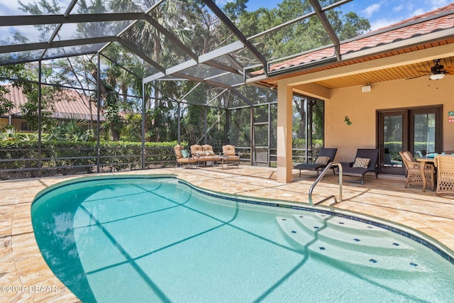 outdoor pool with a ceiling fan, a patio, and a lanai