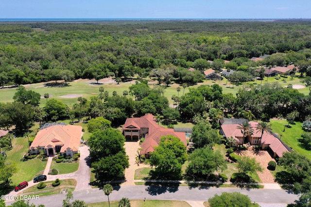 bird's eye view featuring a wooded view and golf course view