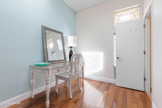 office space featuring baseboards and wood finished floors