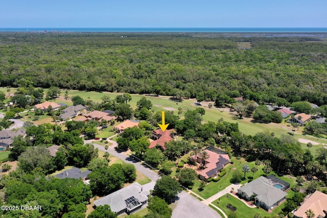aerial view with a wooded view and a residential view