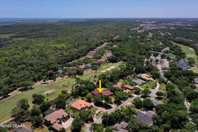 aerial view featuring a wooded view, golf course view, and a residential view