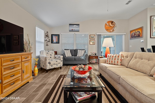 living room featuring dark wood-type flooring and vaulted ceiling