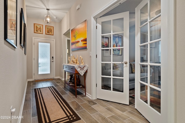 doorway featuring a textured ceiling and french doors