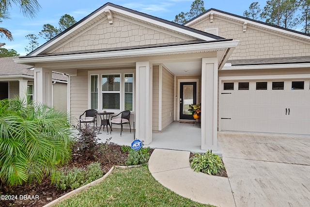 view of front of home featuring a garage and a porch