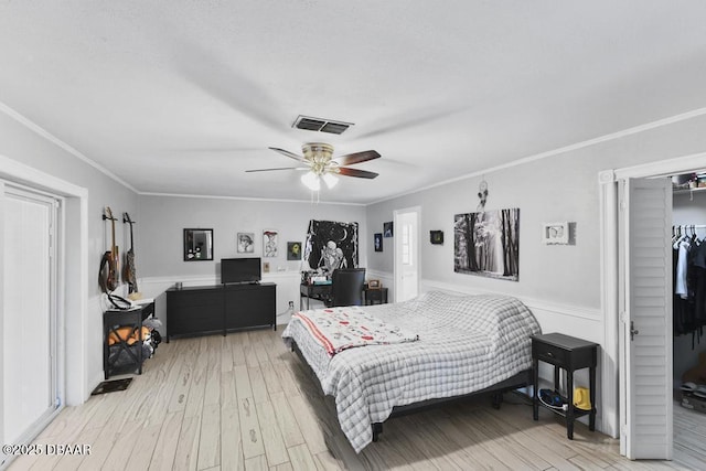 bedroom with ceiling fan, light wood-type flooring, and ornamental molding