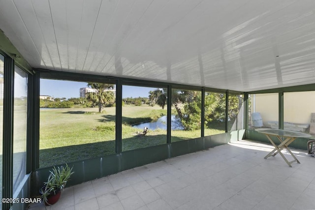 unfurnished sunroom with a water view