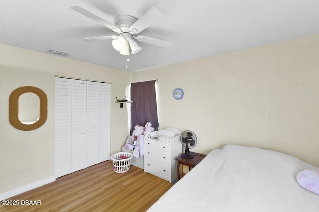 bedroom featuring hardwood / wood-style flooring, ceiling fan, and a closet