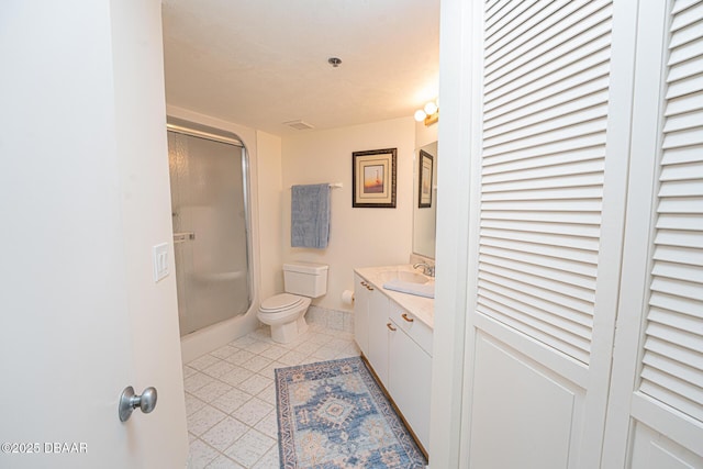 bathroom with vanity, toilet, and an enclosed shower