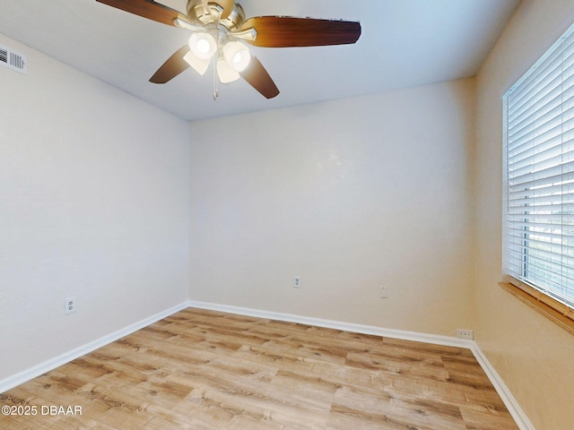 unfurnished room with ceiling fan, plenty of natural light, and light wood-type flooring