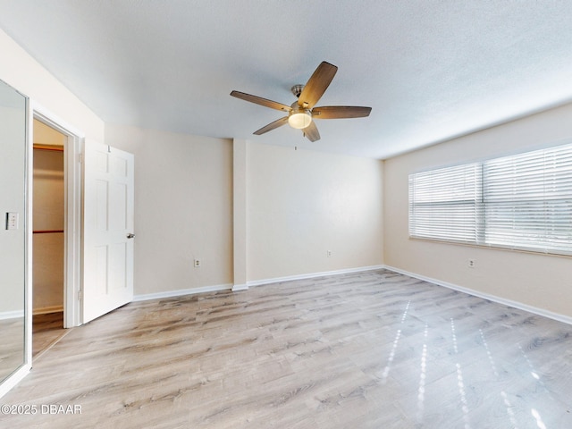 spare room featuring ceiling fan and light hardwood / wood-style floors