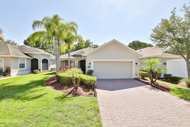 ranch-style home featuring a garage and a front lawn