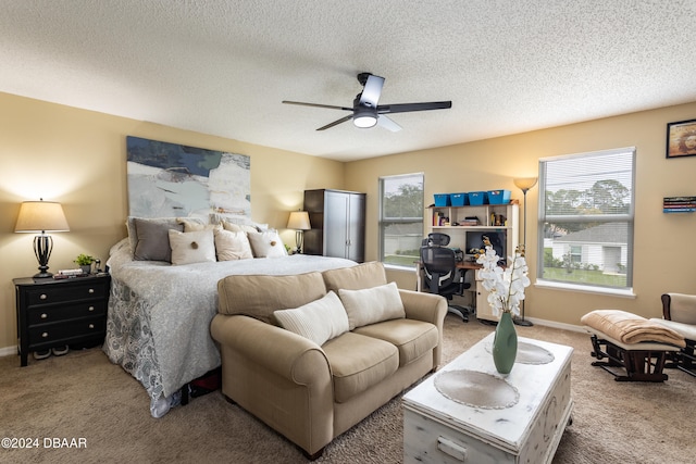 bedroom featuring carpet, a textured ceiling, multiple windows, and ceiling fan