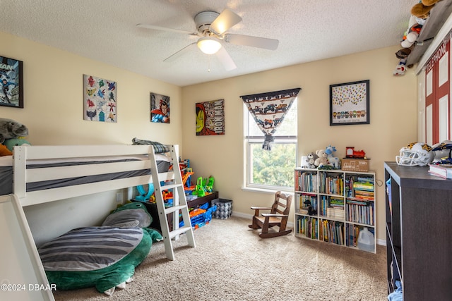 carpeted bedroom featuring ceiling fan and a textured ceiling