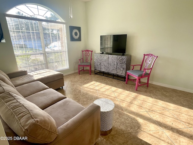 living area featuring tile patterned floors and baseboards